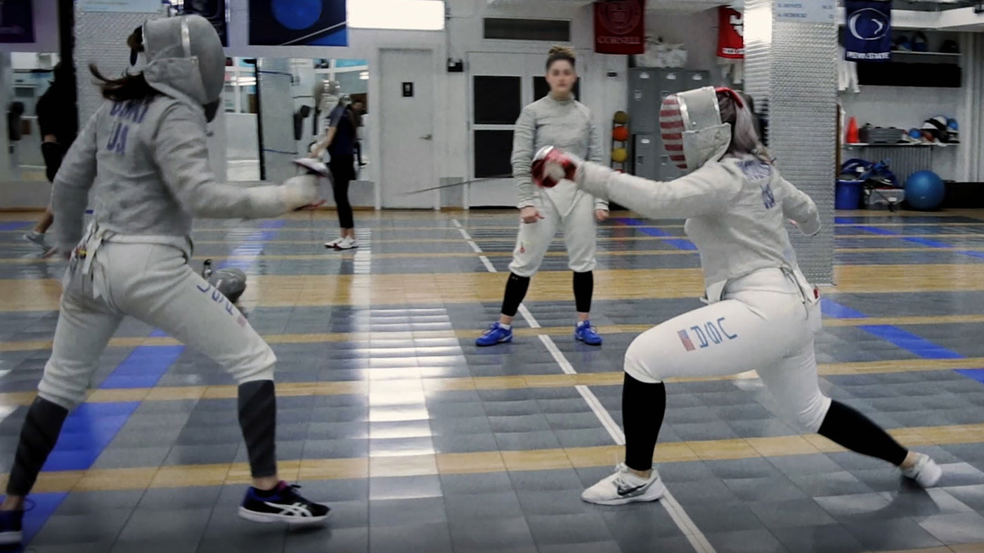Opponents practicing fencing