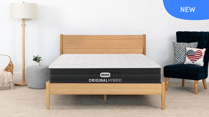 Bear Original Hybrid mattress on a wooden bed frame in a bedroom setting.