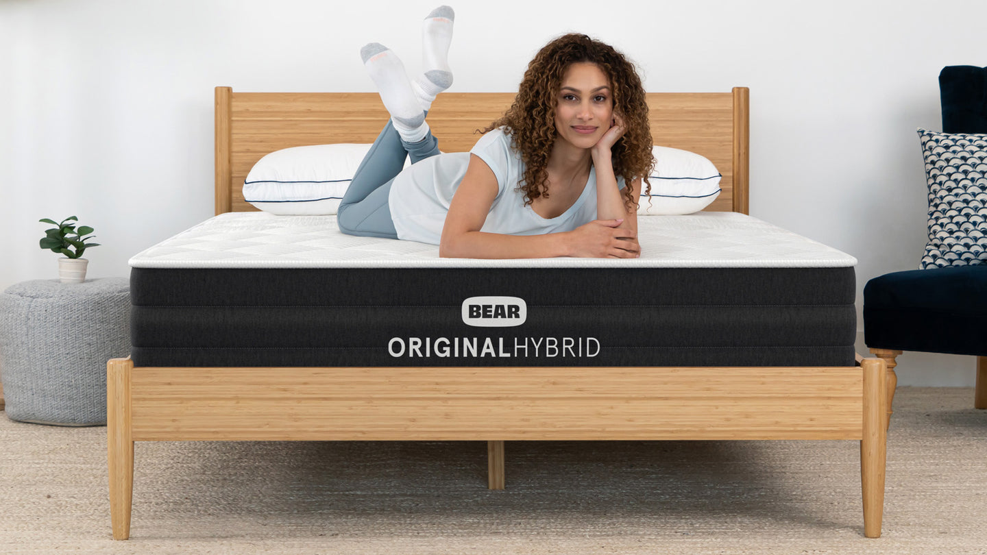 Person resting on Bear Original Hybrid mattress with Celliant cover