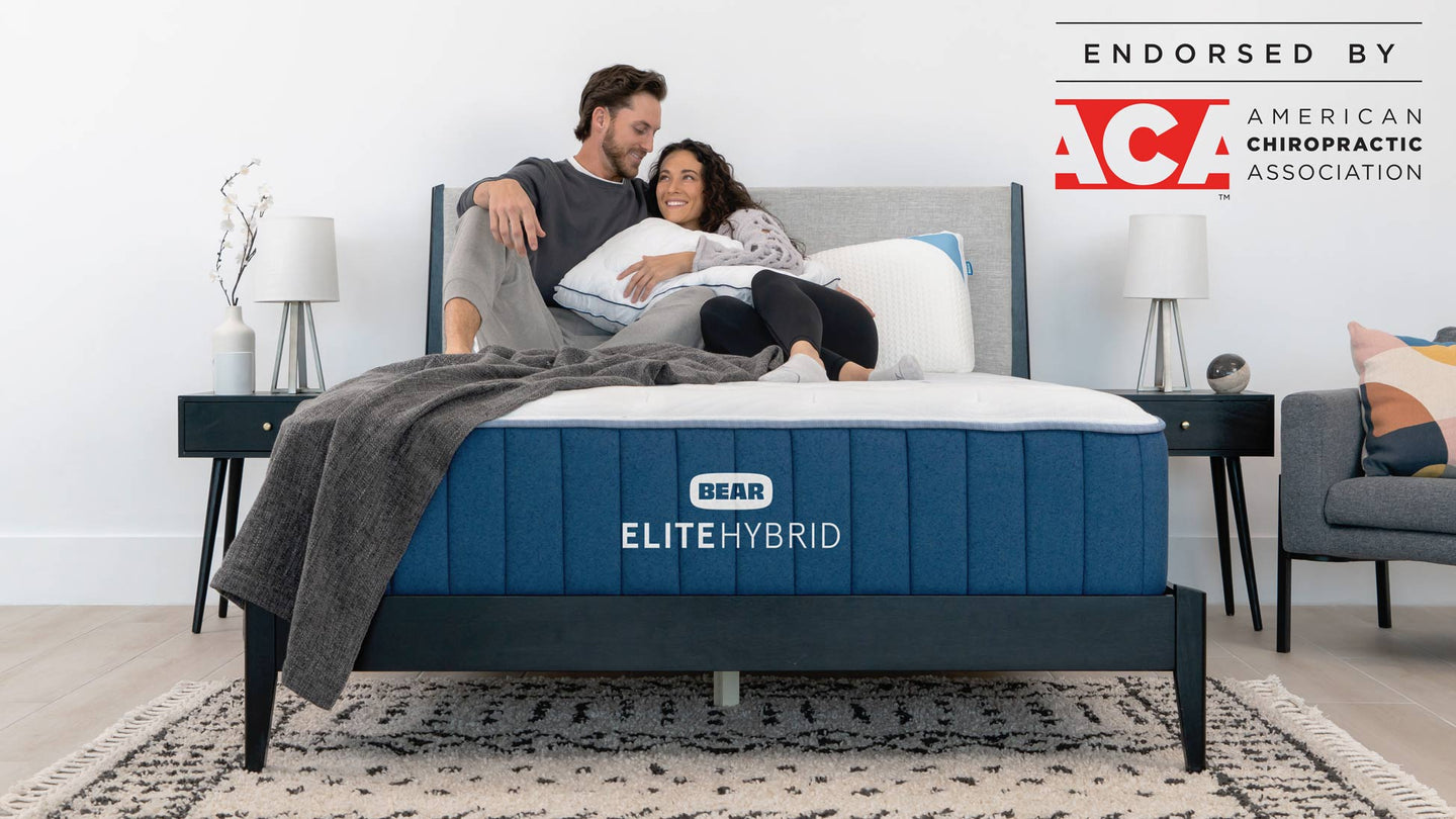 https://www.bearmattress.com/cdn/shop/files/EliteHybrid-Lifestyle-FrontHeroCoupleCuddleWithACA-1948x1096_1440x.jpg?v=1700596252