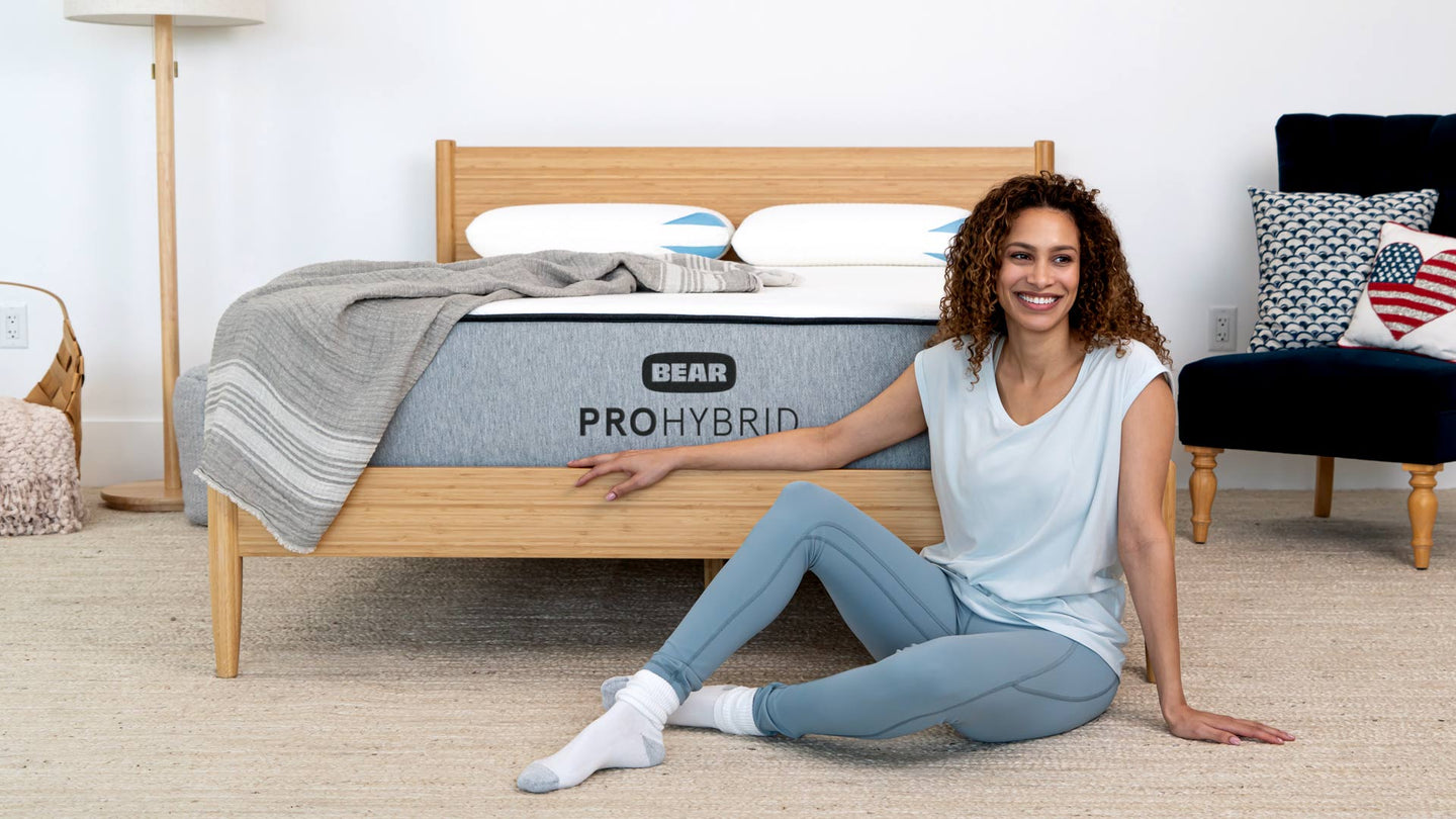 https://www.bearmattress.com/cdn/shop/products/ProHybrid-Lifestyle-HeadonModelInFront-1918x1079_1440x.jpg?v=1703195262